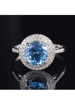 Inel din aur cu anturaj de diamante si piatra topaz bleu